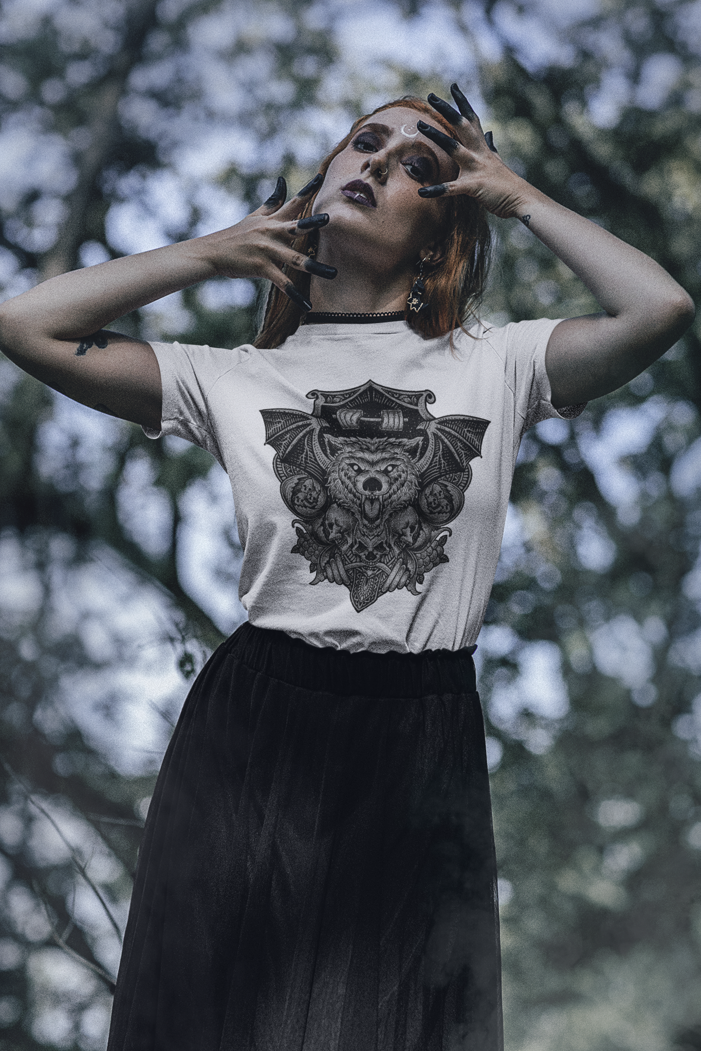 A women wearing a white shirt that embraces the night's horrors with a 'Nocturnal Nightmare Bat' graphic.